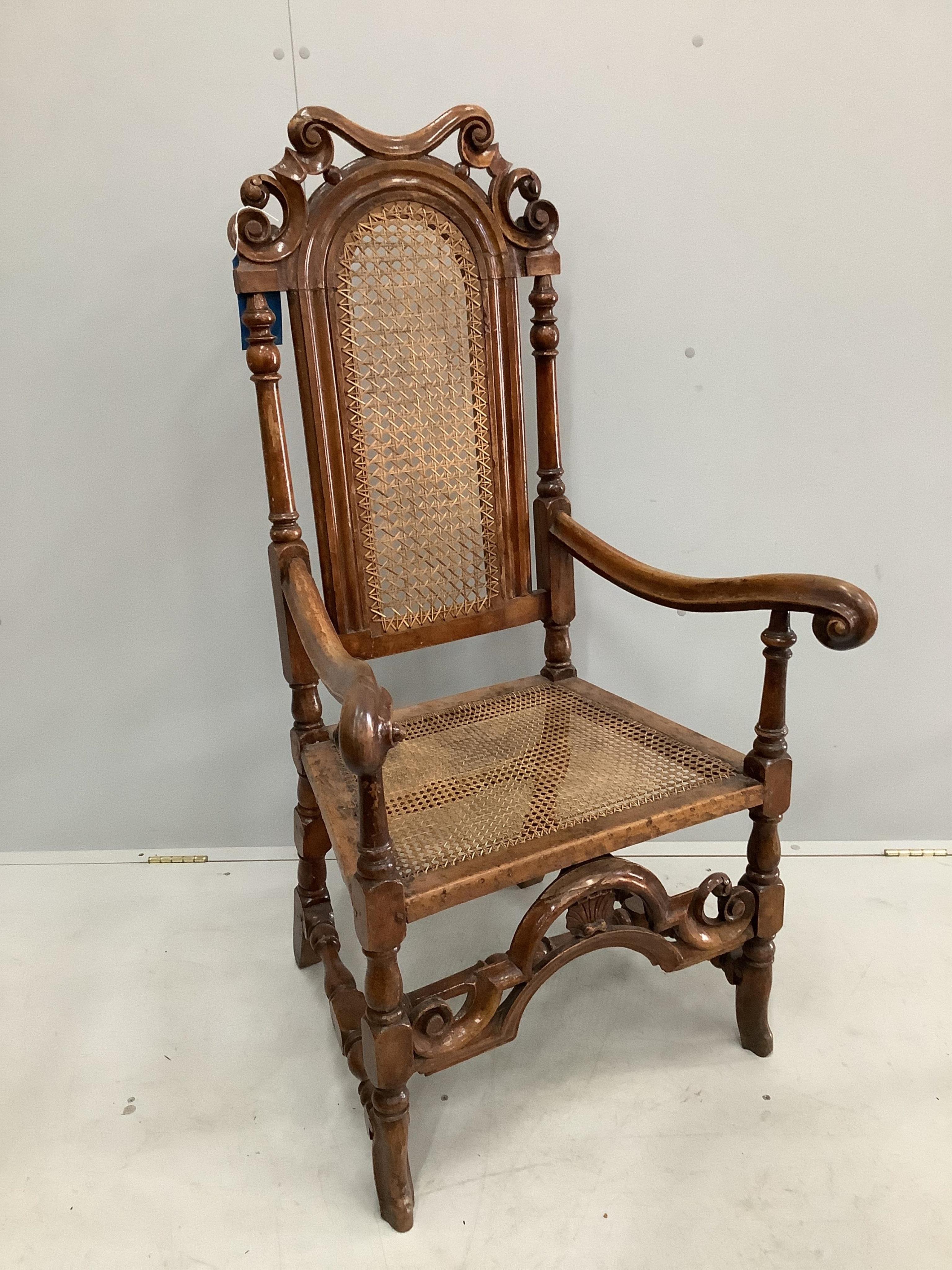 A William and Mary walnut and beech armchair, with a patera carved crest rail, and square and scroll twist legs, united by stretchers, width 66cm, depth 56cm, height 124cm. Condition - fair